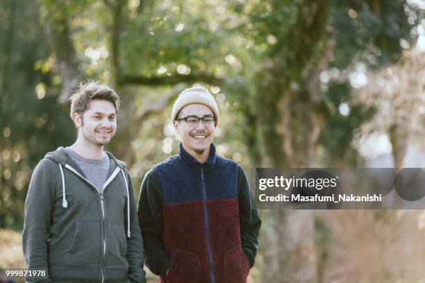 two friendly men in the park - masafumi nakanishi stock pictures, royalty-free photos & images
