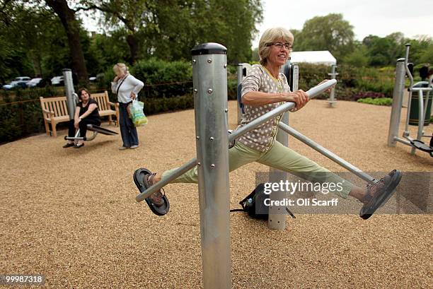 Tessa Morrison is watched by Katherine Thompson and Jill Jones as she exercises in London's first purpose built 'Senior Playground' in Hyde Park on...