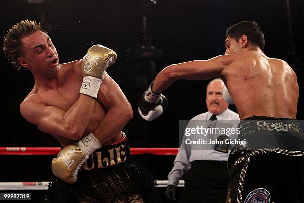 Amir Khan of Great Britain hits Paulie Malignaggi during the WBA light welterweight title fight at Madison Square Garden on May 15, 2010 in New York...