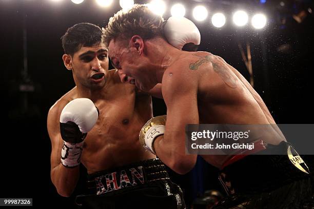 Amir Khan of Great Britain hits Paulie Malignaggi during the WBA light welterweight title fight at Madison Square Garden on May 15, 2010 in New York...