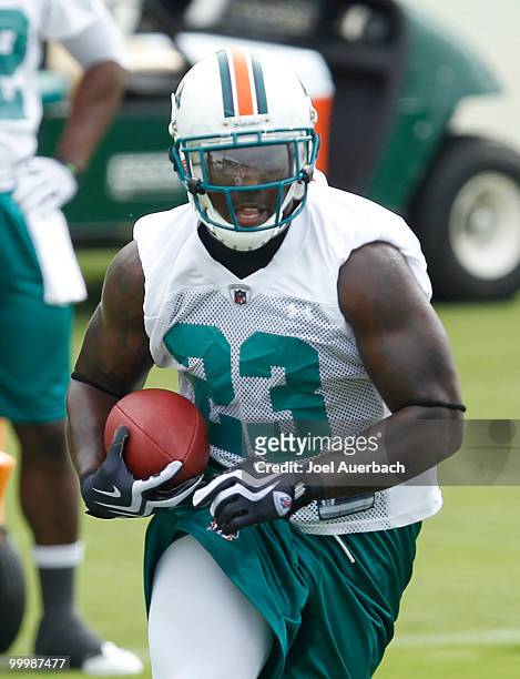 Ronnie Brown of the Miami Dolphins runs with the ball during the organized team activities on May 19, 2010 at the Miami Dolphins training facility in...