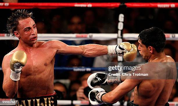 Paulie Malignaggi hits Amir Khan of Great Britain during the WBA light welterweight title fight at Madison Square Garden on May 15, 2010 in New York...