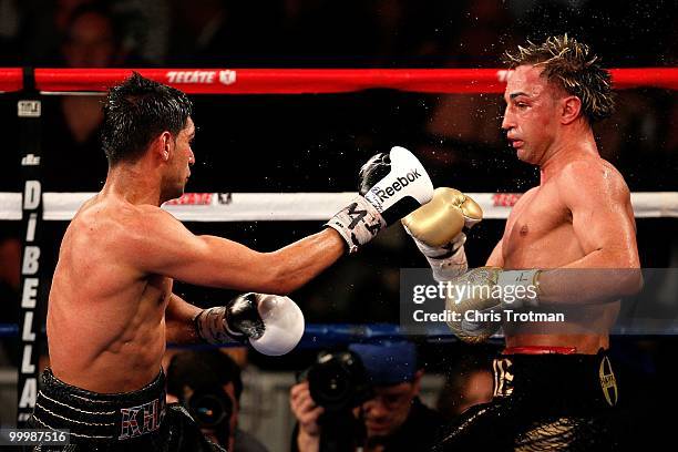 Amir Khan of Great Britain hits Paulie Malignaggi during the WBA light welterweight title fight at Madison Square Garden on May 15, 2010 in New York...