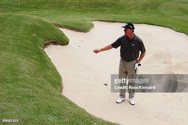 Ernie Els of South African prepares to play a bunker shot during the Pro-Am round prior to the BMW PGA Championship on the West Course at Wentworth...