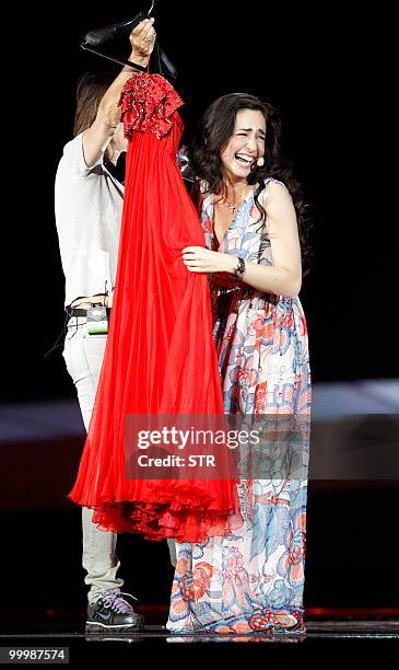 Sofia Nizharadze from Georgia bursts into laughter as she is shown a red dress after she sang "Shine" during the rehearsals before the Eurovision...