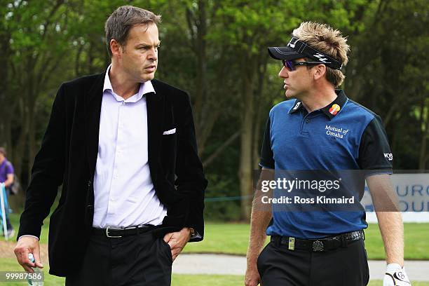Businessman Peter Jones talks with Ian Poulter of England during the Pro-Am round prior to the BMW PGA Championship on the West Course at Wentworth...