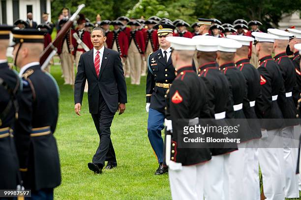 President Barack Obama reviews the troops during an official state arrival for Felipe Calderon, Mexico's president, on the South Lawn of the White...