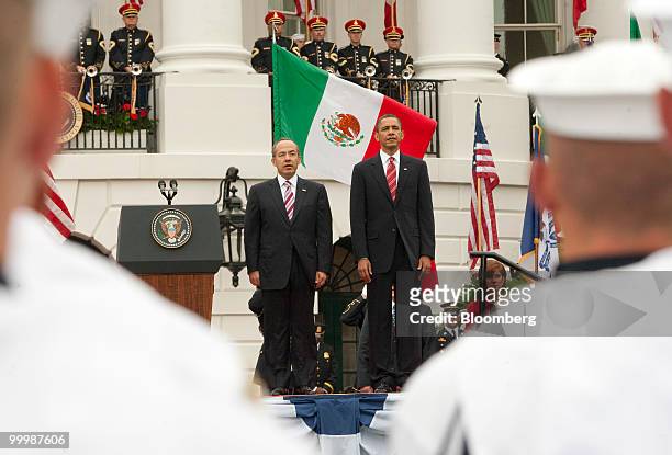 President Barack Obama, right, and Felipe Calderon, Mexico's president, stand during the national anthem at an official state arrival on the South...