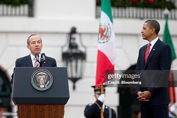 Felipe Calderon, Mexico's president, left, speaks during an official state arrival on the South Lawn of the White House with U.S. President Barack...