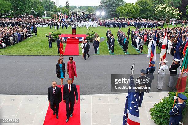 President Barack Obama, front right, and Felipe Calderon, Mexico's president, front left, walk towards the White House during an official state...