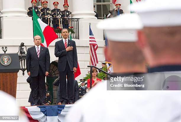 President Barack Obama, right, and Felipe Calderon, Mexico's president, stand as the national anthem is played during an official state arrival on...
