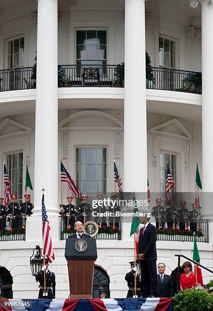 Felipe Calderon, Mexico's president, left, speaks during an official state arrival on the South Lawn of the White House with U.S. President Barack...