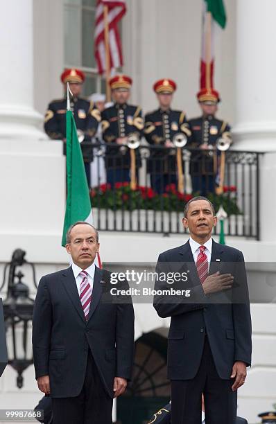 President Barack Obama, right, and Felipe Calderon, Mexico's president, stand during the national anthem at an official state arrival on the South...