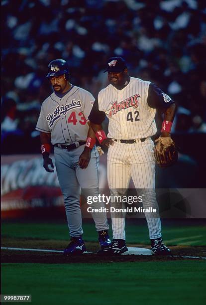 Mo Vaughn of the Anaheim Angels stands at first with Raul Mondesi of the Los Angeles Dodgers during the game at Edison International Field on July...