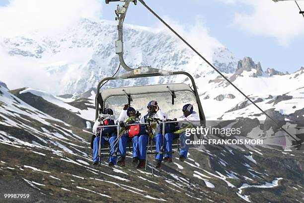 France's football players Steve Mandanda, Sidney Govou, Abou Diaby and Lassana Diarra sit in a ski lift to reach the Tignes glacier on May 19, 2010...