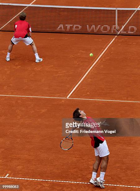 Daniel Gimeno-Traver and Marc Lopez of Spain serve during their match against Bob Bryan and Mike Bryan of USA during day four of the ARAG World Team...