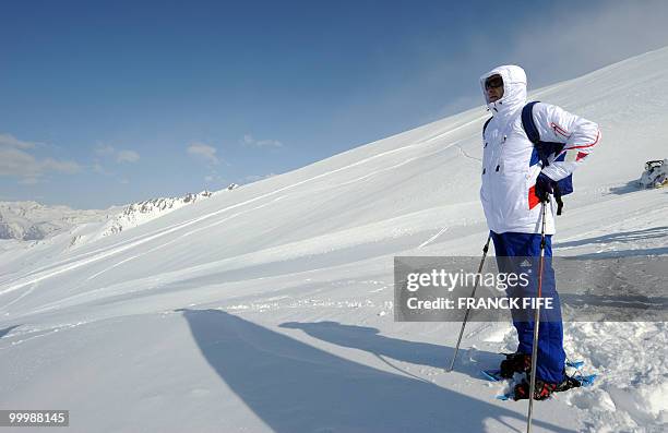 French national football team's coach looks at the view upon his arrival at the top of the Tignes glacier on May 19, 2010 in the French Alps. The...