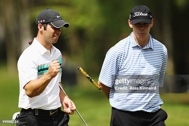 Paul Casey of England reacts to a shot alongside playing partner Sir Clive Woodward during the Pro-Am round prior to the BMW PGA Championship on the...