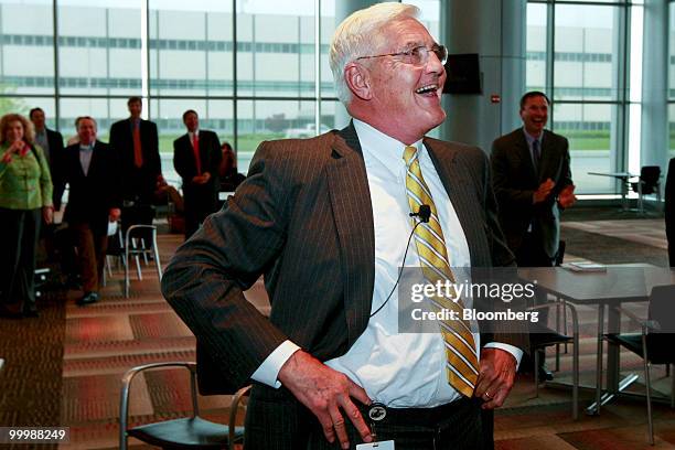 Robert "Bob" Lutz, former vice chairman of General Motors Co. , smiles as he watches a video during a retirement party for Lutz at the GM Vehicle...