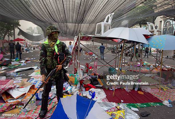 Soldier stands guard after Thai military forces cleared the main rally site inside the red shirt anti-government protesters' camp on May 19, 2010 in...