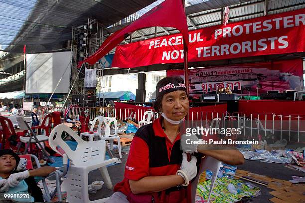Red shirt anti-government protester sits down on a chair at the main rally site inside the red shirt anti-government protesters' camp after Thai...