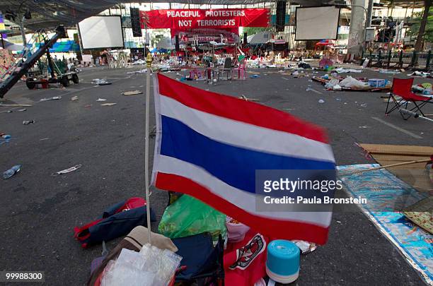 Thai flag blows in the wind after Thai military forces cleared the main rally site inside the red shirt anti-government protesters' camp on May 19,...