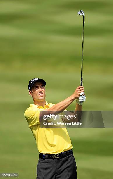 Ross Fisher of England hits his 3rd shot on the 4th hole during the Pro-Am round prior to the BMW PGA Championship on the West Course at Wentworth on...