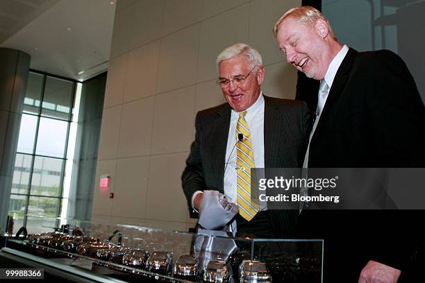 Robert "Bob" Lutz, former vice chairman of General Motors Co. , left, is presented with a gift of 11 model cars that he helped design by Tom...