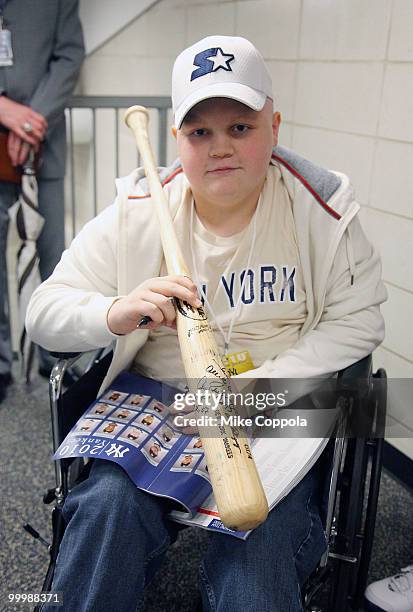 Jack Williams poses with a bat signed by New York Yankees third baseman Alex Rodriguez at the starter event at NY Yankees batting practice at Yankee...