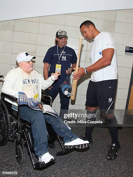 Jack Williams and Roger Williams have a bat signed by New York Yankees 3rd baseman Alex Rodriguez at the starter event at NY Yankees batting practice...