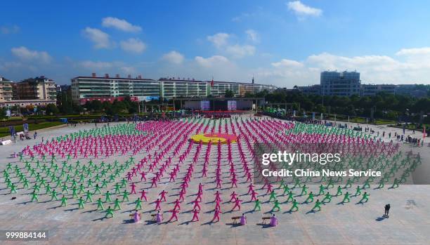 Aerial view of 1,680 Tai Chi enthusiasts from all over the world performing Tai Chi on a square of Guangchang County on July 14, 2018 in Fuzhou,...