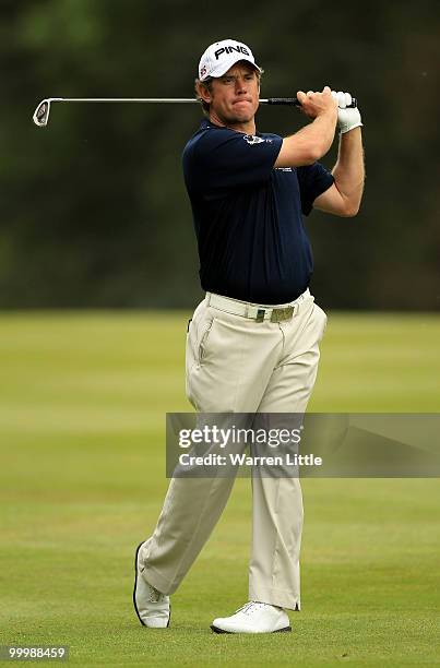 Lee Westwood of England hits an approach shot during the Pro-Am round prior to the BMW PGA Championship on the West Course at Wentworth on May 19,...