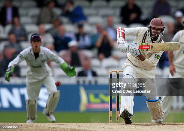 Arun Harinath of Surrey hits the ball in front of Middlesex wicketkeeper John Simpson during the LV County Championship Division Two match between...