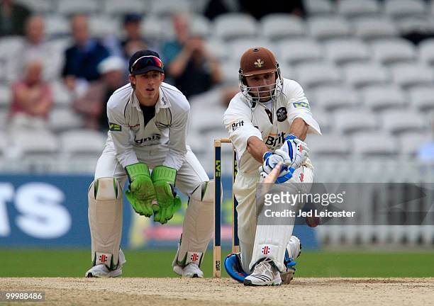 Mark Ramprakash of Surrey sweeps the ball away from Middlesex wicketkeeper John Simpson during the LV County Championship Division Two match between...