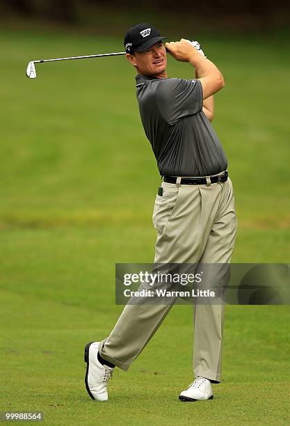 Ernie Els of South Africa hits an approach shot during the Pro-Am round prior to the BMW PGA Championship on the West Course at Wentworth on May 19,...