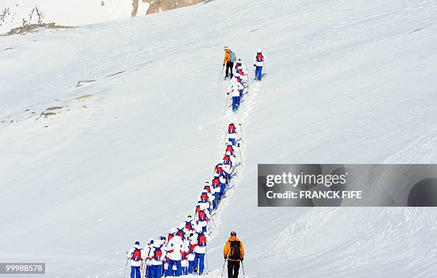 French national football team's players train at the top of the Tignes glacier on May 19, 2010 in the French Alps. The French national team should...