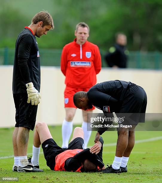 England coach Stuart Pearce looks on as Robert Green and Jermain Defoe check on Matthew Upson after he was injured during an England training session...
