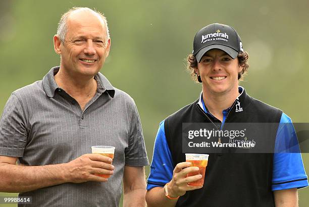 Ron Dennis enjoys a glass of Pimms with Rory McIlroy of Northern Ireland during the Pro-Am round prior to the BMW PGA Championship on the West Course...