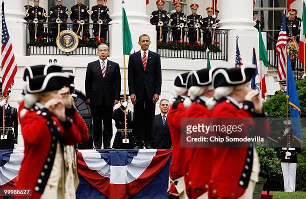 President Barack Obama and Mexican President Felipe Calderon review the U.S. Army's Old Guard Fife and Drum Corps during a ceremony on the South Lawn...
