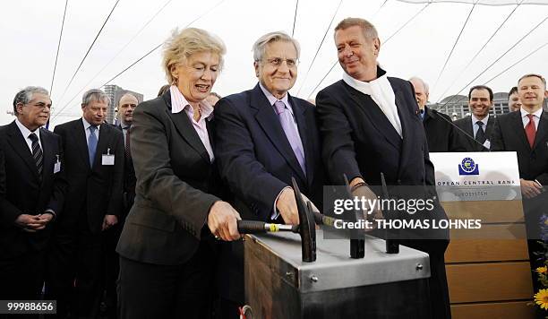 Frankfurt's Mayor Petra Roth, European Central Bank President Jean-Claude Trichet and architect Wolf D. Prix hold hammers as they close a box to be...