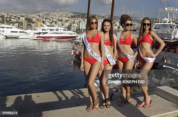 Models pose in front of boats during the 2010 Beirut Boat Show at a beach resort in Dbayeh, north of the Lebanese capital, on May 19, 2010. AFP...