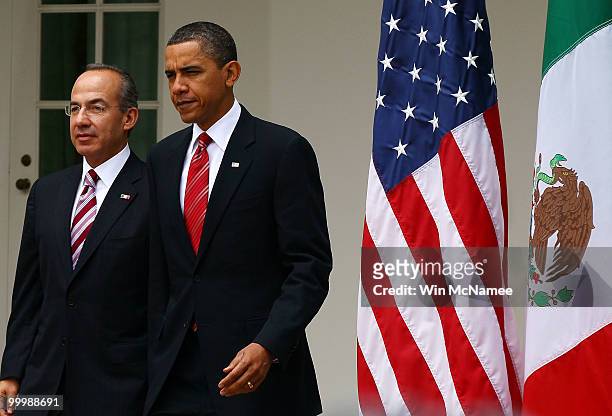 President Barack Obama and Mexican President Felipe Calderon arrive for a joint press conference in the Rose Garden of the White House during an...