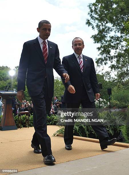 Mexico�s President Felipe Calderón and US President Barack Obama make their way from a joint press conference May 19, 2010 in the Rose Garden of the...