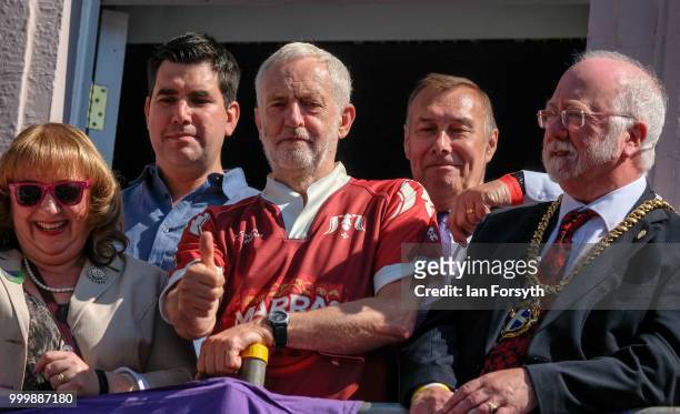 Labour Leader Jeremy Corbyn gestures as he stands on the balcony of the County Hotel watching as colliery bands pass below during the 134th Durham...