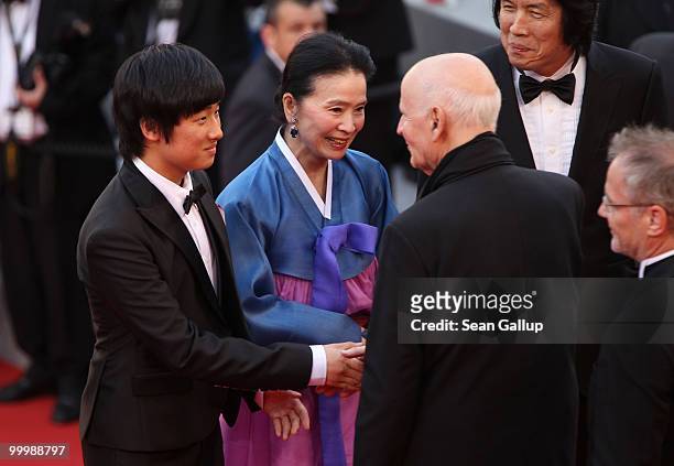 Cannes Film Festival President Gilles Jacob greets actress Jeong-hee Yoon and actor David Lee at the "Poetry" Premiere at the Palais des Festivals...