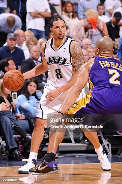 Deron Williams of the Utah Jazz dribbles against Derek Fisher of the Los Angeles Lakers in Game Four of the Western Conference Semifinals during the...