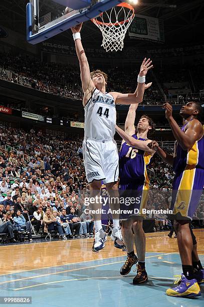 Kyrylo Fesenko of the Utah Jazz goes up with the ball against Pau Gasol and Andrew Bynum of the Los Angeles Lakers in Game Four of the Western...