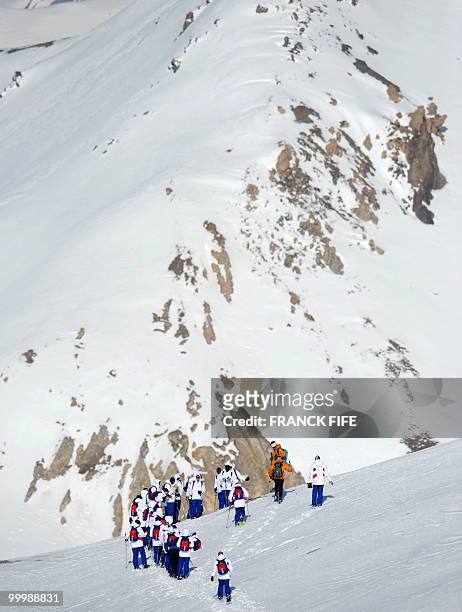 French national football team's players walk with snowshoes at the top of the Tignes glacier on May 19, 2010 in the French Alps. The French national...