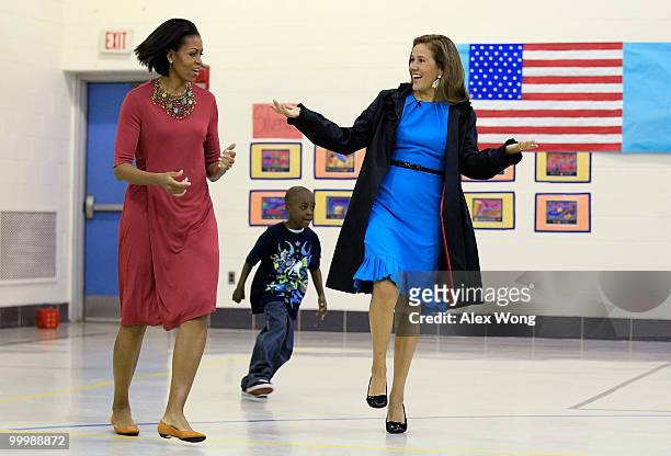 First lady Michelle Obama and her Mexican counterpart Margarita Zavala run with second graders during a physical education class as they visit New...