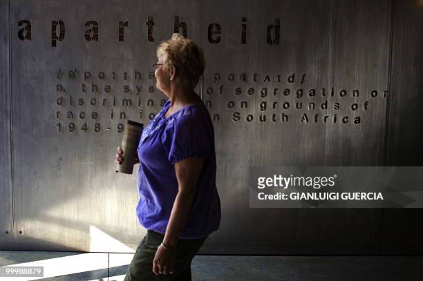 Woman walks by the main entrance to the segregation history exhibition on May 19, 2010 at the Apartheid museum in Johannesburg, South Africa. The...